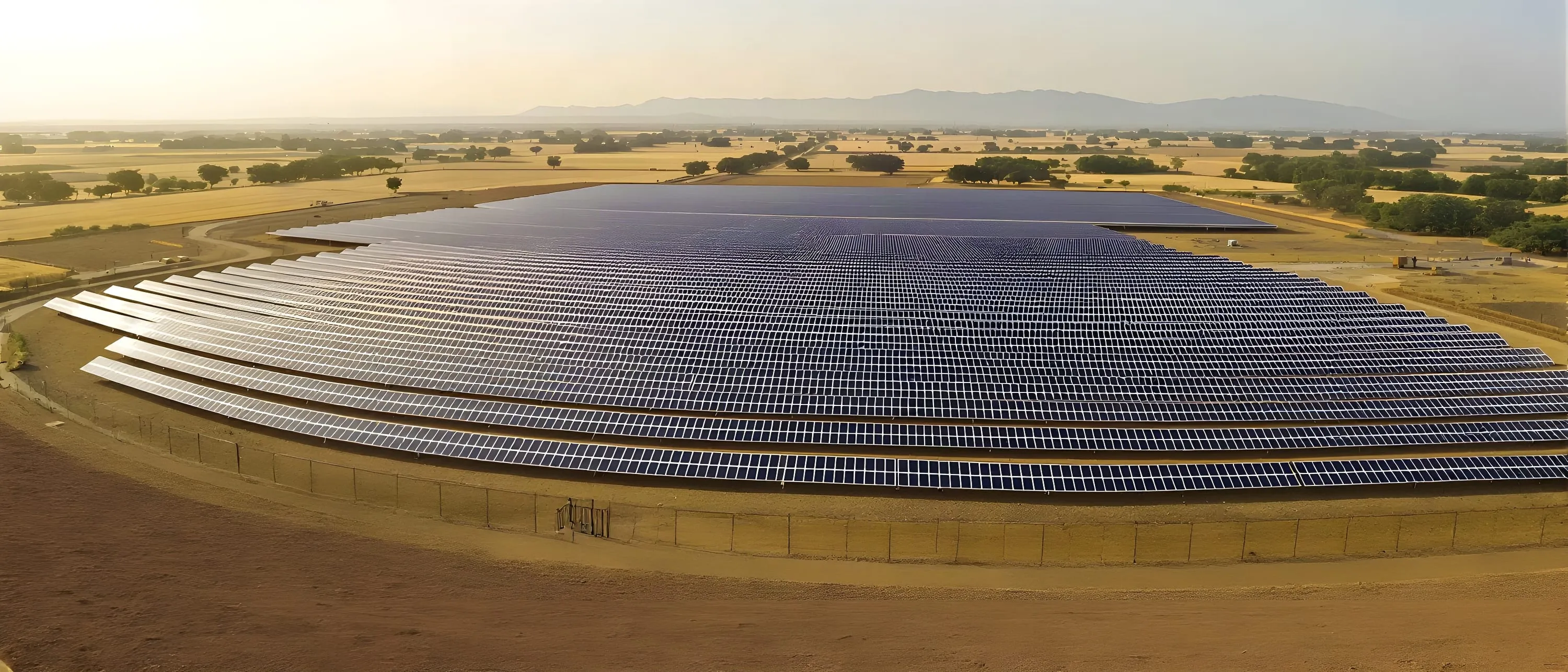 Illustrative image: a ground-mounted solar plant among farmland